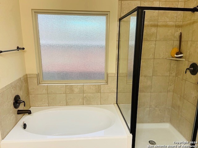 bathroom with separate shower and tub