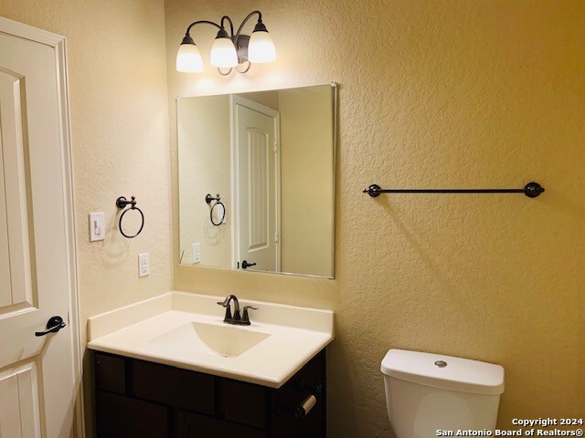 bathroom featuring toilet and vanity