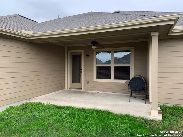 property entrance featuring a patio area and ceiling fan