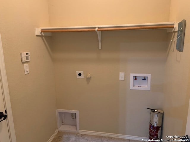 laundry area featuring gas dryer hookup, tile patterned floors, hookup for an electric dryer, and hookup for a washing machine