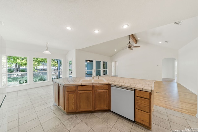 kitchen featuring tile countertops, sink, white dishwasher, light tile patterned floors, and pendant lighting