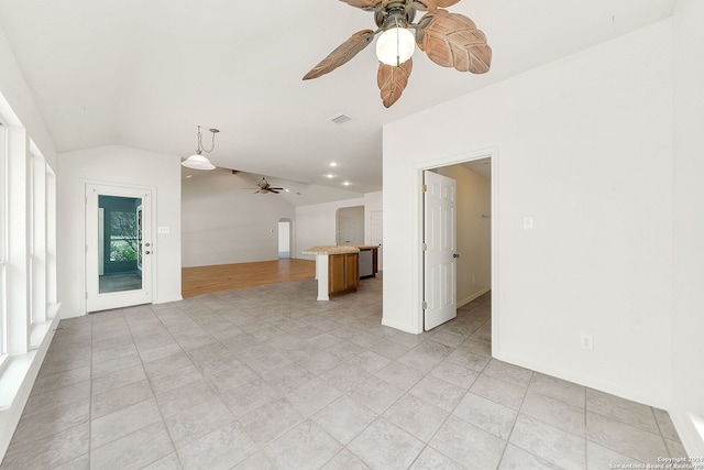 unfurnished living room featuring ceiling fan and vaulted ceiling