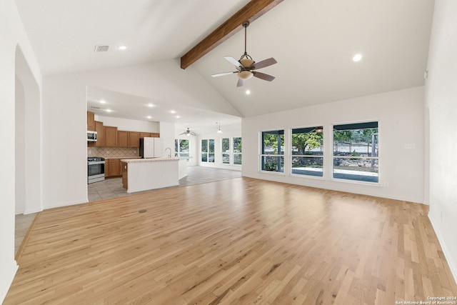 unfurnished living room featuring high vaulted ceiling, light hardwood / wood-style flooring, ceiling fan, and beam ceiling