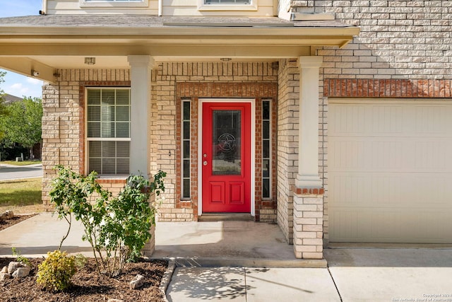 property entrance featuring a garage and a porch