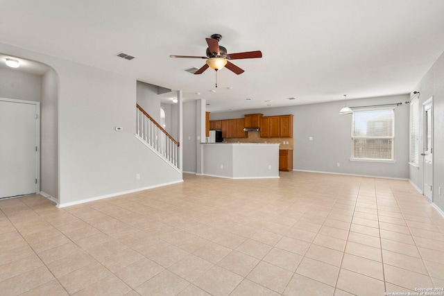 unfurnished living room with light tile patterned flooring and ceiling fan