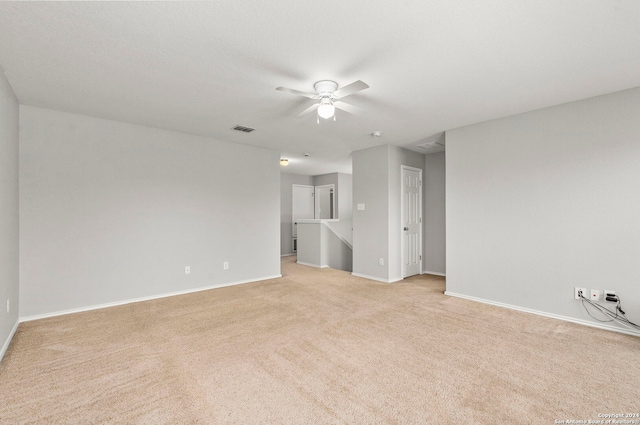 carpeted empty room featuring ceiling fan