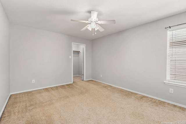 unfurnished room with light carpet and ceiling fan