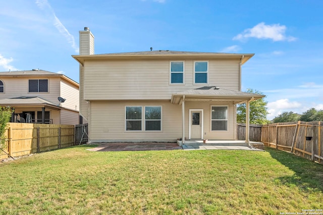 back of house featuring a yard and a patio area