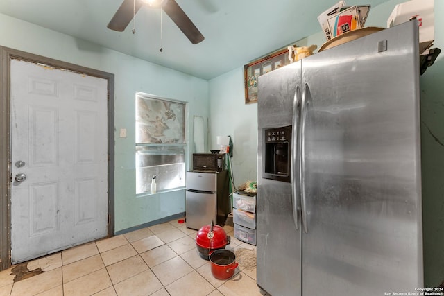 kitchen with stainless steel fridge with ice dispenser, ceiling fan, light tile patterned flooring, and stainless steel fridge