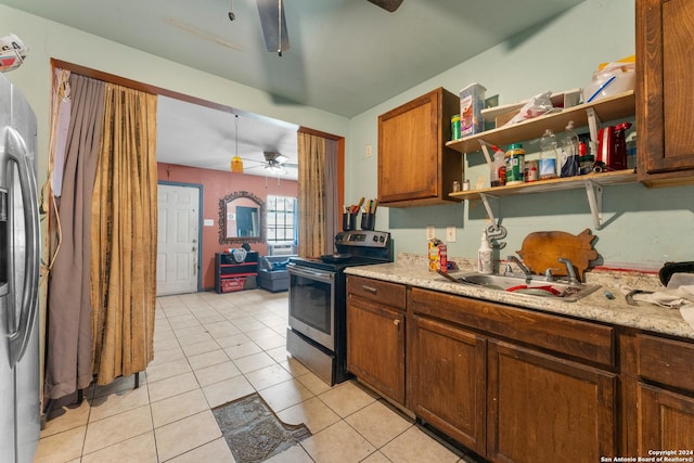 kitchen with ceiling fan, sink, light tile patterned flooring, appliances with stainless steel finishes, and light stone counters