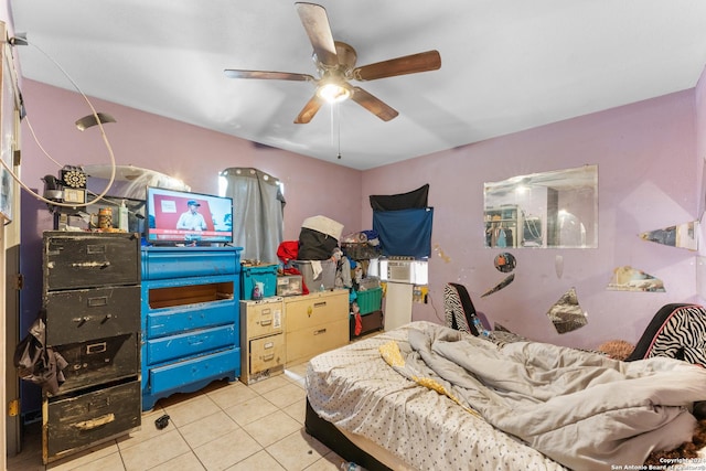 tiled bedroom featuring ceiling fan