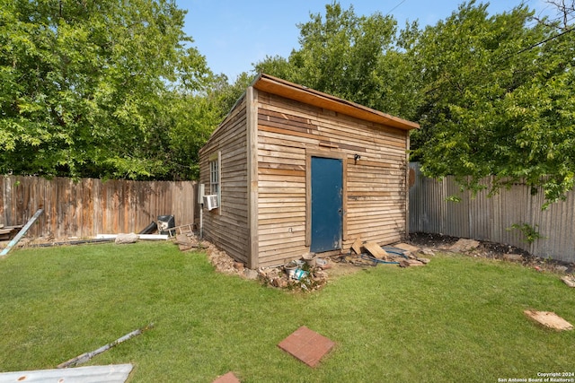 view of outbuilding featuring a yard