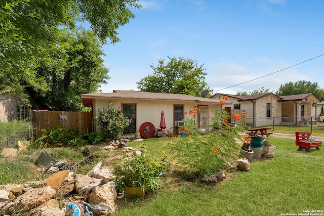 rear view of house featuring a yard