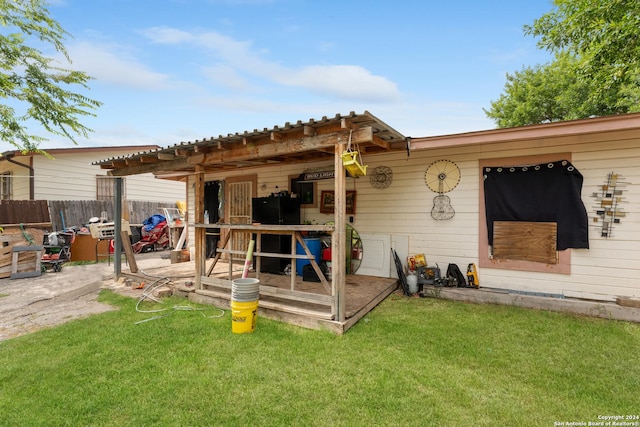 back of house with a patio area and a lawn