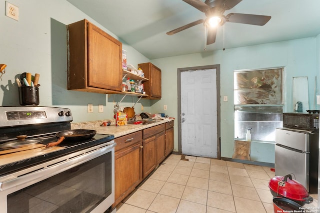 kitchen with ceiling fan, sink, light tile patterned floors, and stainless steel appliances