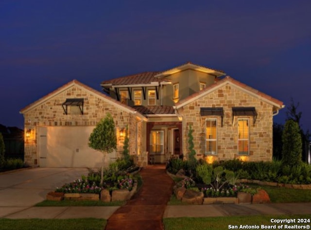 mediterranean / spanish home with a garage