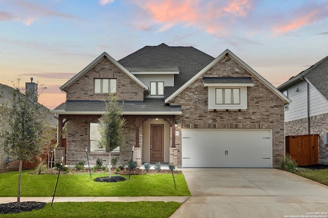 craftsman inspired home featuring a lawn and a garage