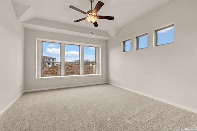 carpeted empty room featuring ceiling fan and vaulted ceiling