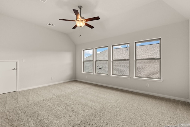 unfurnished room featuring ceiling fan, carpet floors, and vaulted ceiling