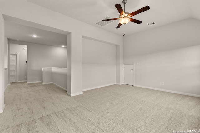 carpeted spare room with ceiling fan and lofted ceiling