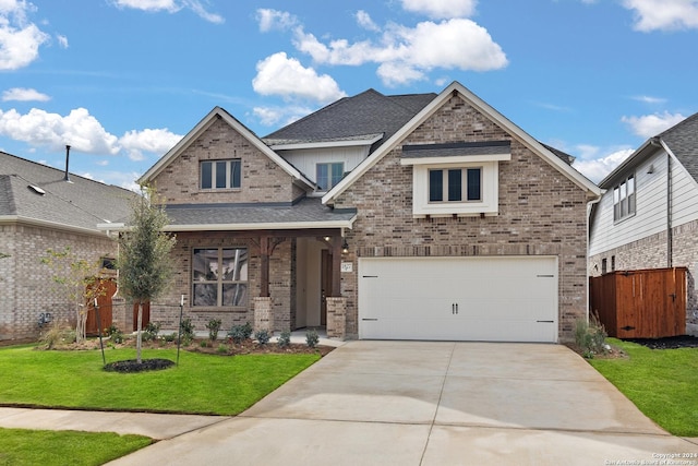 craftsman house with a front lawn and a garage