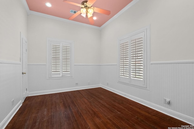 spare room with wood-type flooring, ornamental molding, and ceiling fan