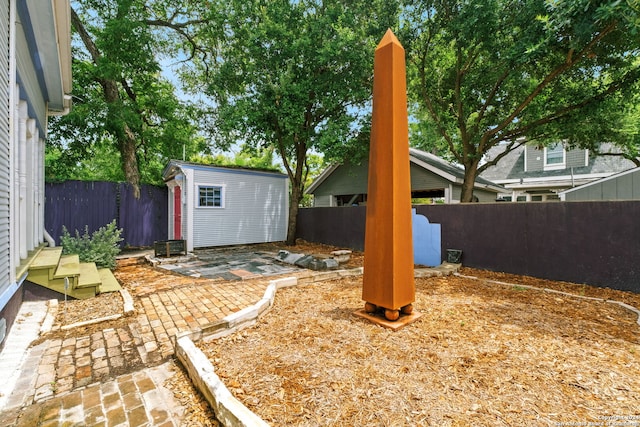 view of yard featuring a patio and a shed