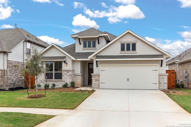 view of front of home with stucco siding, a shingled roof, concrete driveway, a front yard, and a garage