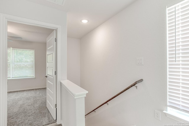 corridor featuring light colored carpet