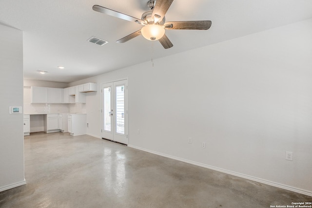 unfurnished living room with ceiling fan and french doors