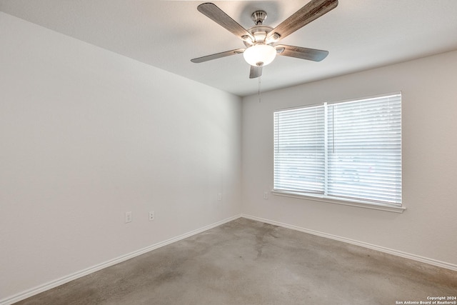 spare room with ceiling fan and light colored carpet