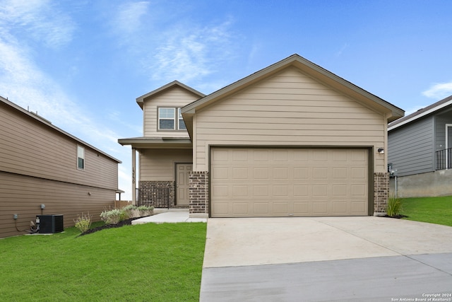 view of front of house with cooling unit, a garage, and a front yard