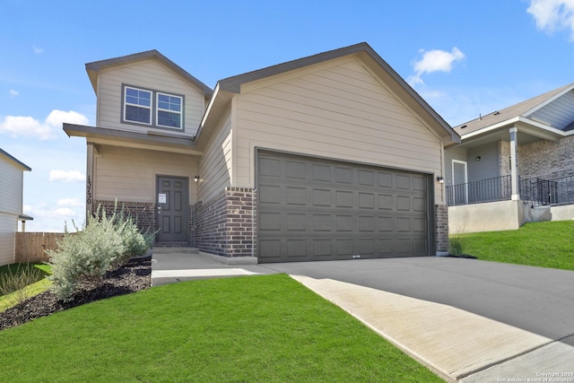 view of front facade featuring driveway, brick siding, a front lawn, and an attached garage