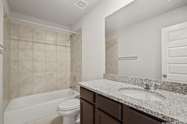 bathroom with bathtub / shower combination, toilet, vanity, visible vents, and tile patterned floors