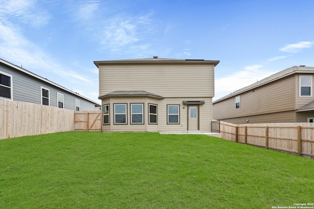 rear view of property with a yard