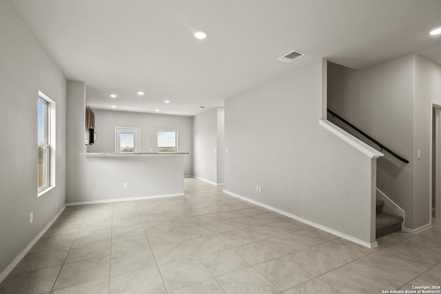 unfurnished room with recessed lighting, visible vents, stairway, and baseboards