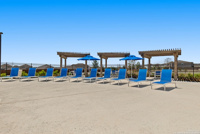 view of playground with a pergola and a patio