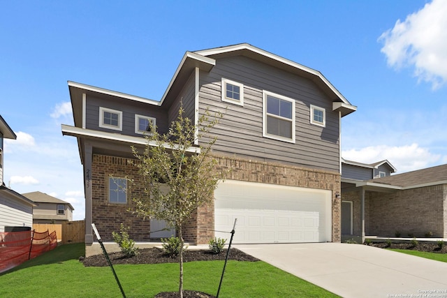 view of front of home featuring brick siding, fence, concrete driveway, a front yard, and a garage