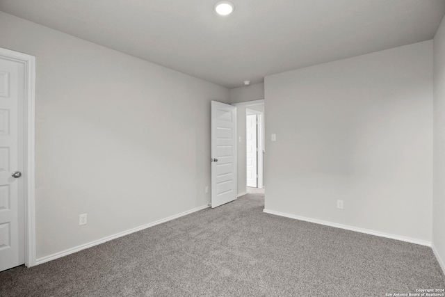 carpeted spare room with baseboards