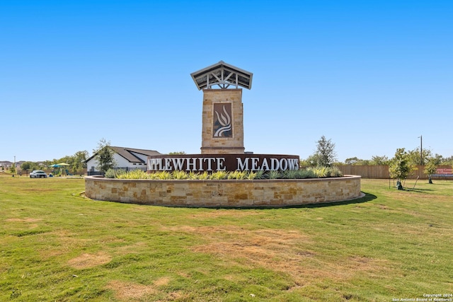 community / neighborhood sign with a lawn