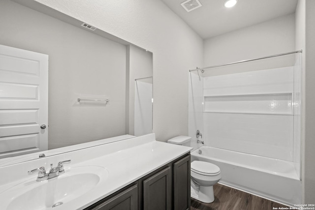 bathroom featuring toilet, vanity, wood finished floors, and visible vents