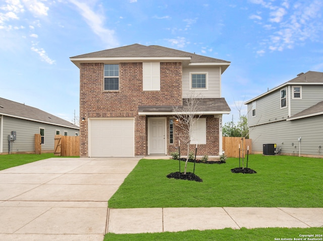 view of property with a garage, central air condition unit, and a front yard