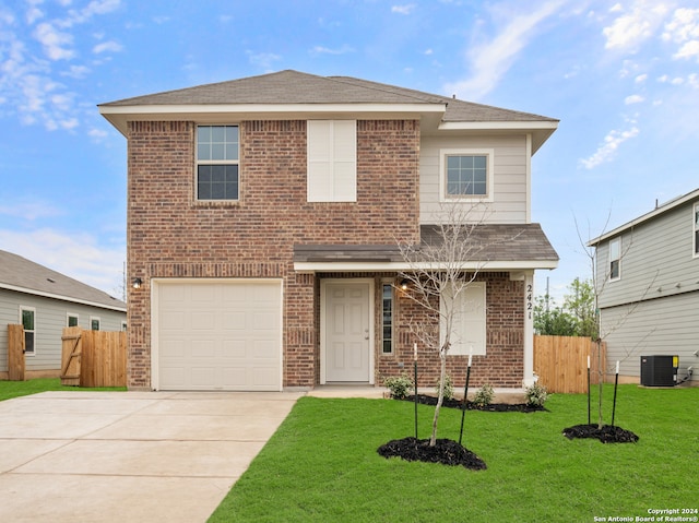 front facade with a garage, central AC, and a front yard