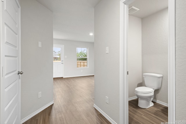 hallway with hardwood / wood-style floors