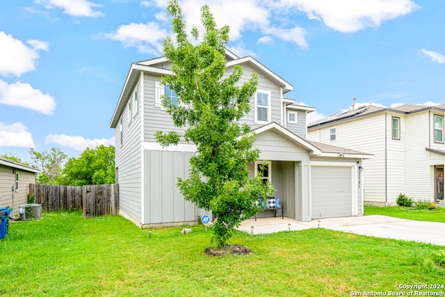 view of front of property with a garage and a front yard