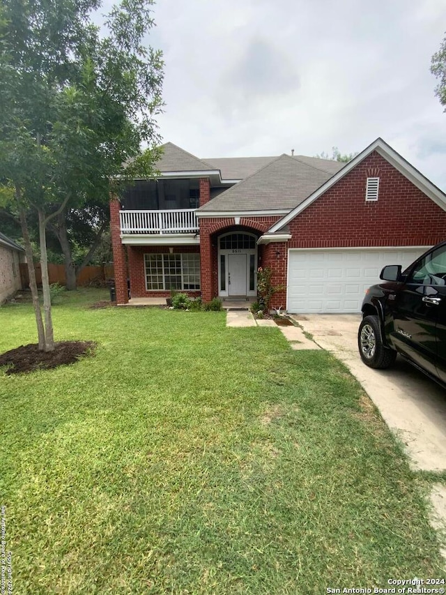 view of front of home with brick siding, driveway, an attached garage, and a front lawn