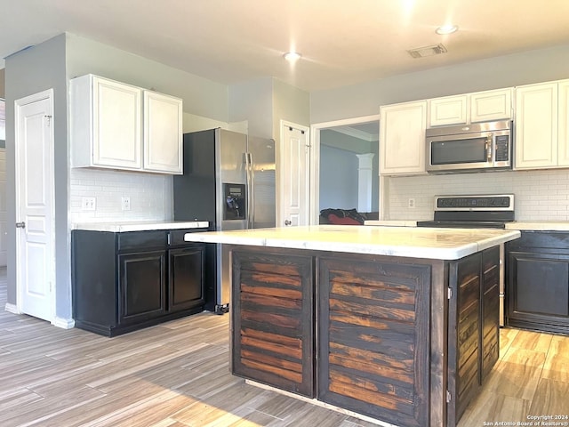 kitchen featuring visible vents, light countertops, light wood-type flooring, white cabinets, and stainless steel appliances