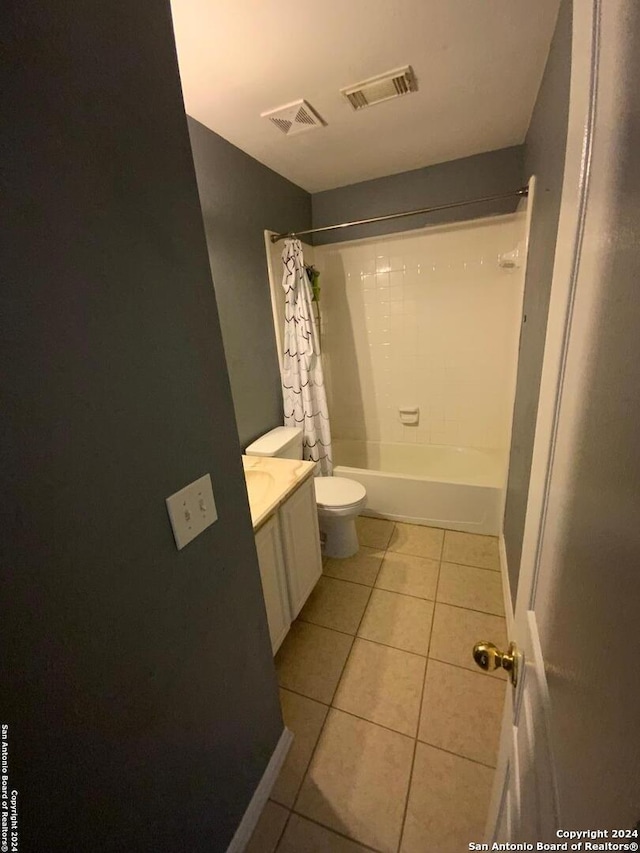 full bathroom featuring vanity, toilet, tile patterned floors, and shower / bath combination with curtain