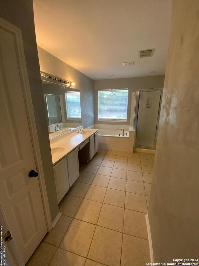 bathroom with shower with separate bathtub, double sink vanity, and tile patterned flooring