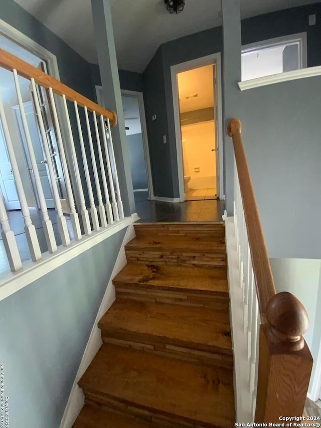 stairs featuring tile patterned flooring